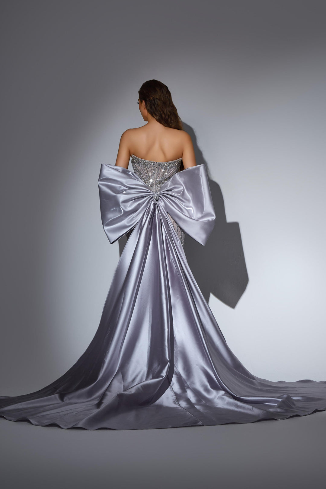 Delilah LD11486 Strapless Sweetheart Beaded Corset Sheath Gown with Oversized Back Bow Train - Grey back view