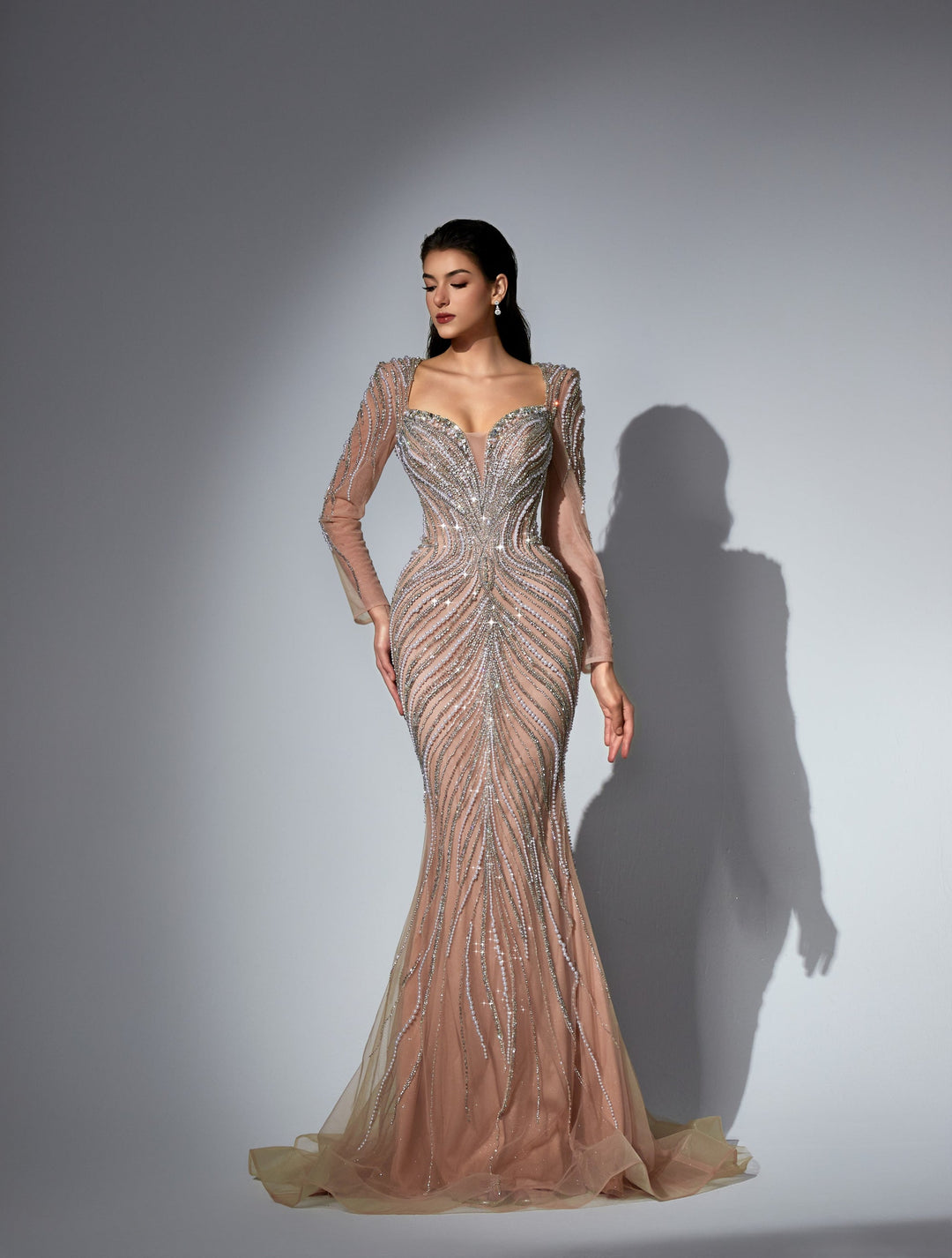 Delilah LD11475 Plunging Illusion Long Sleeve Beaded Corset Sheath Gown with Overskirt - Champagne front view