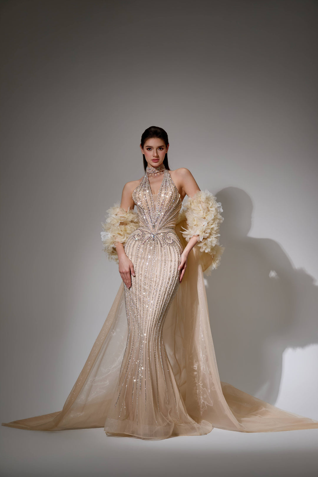 Delilah SH12045 Beaded Halter Plunging Mermaid Gown with Ruffled Arm Puffs and Overskirt - Champagne front view