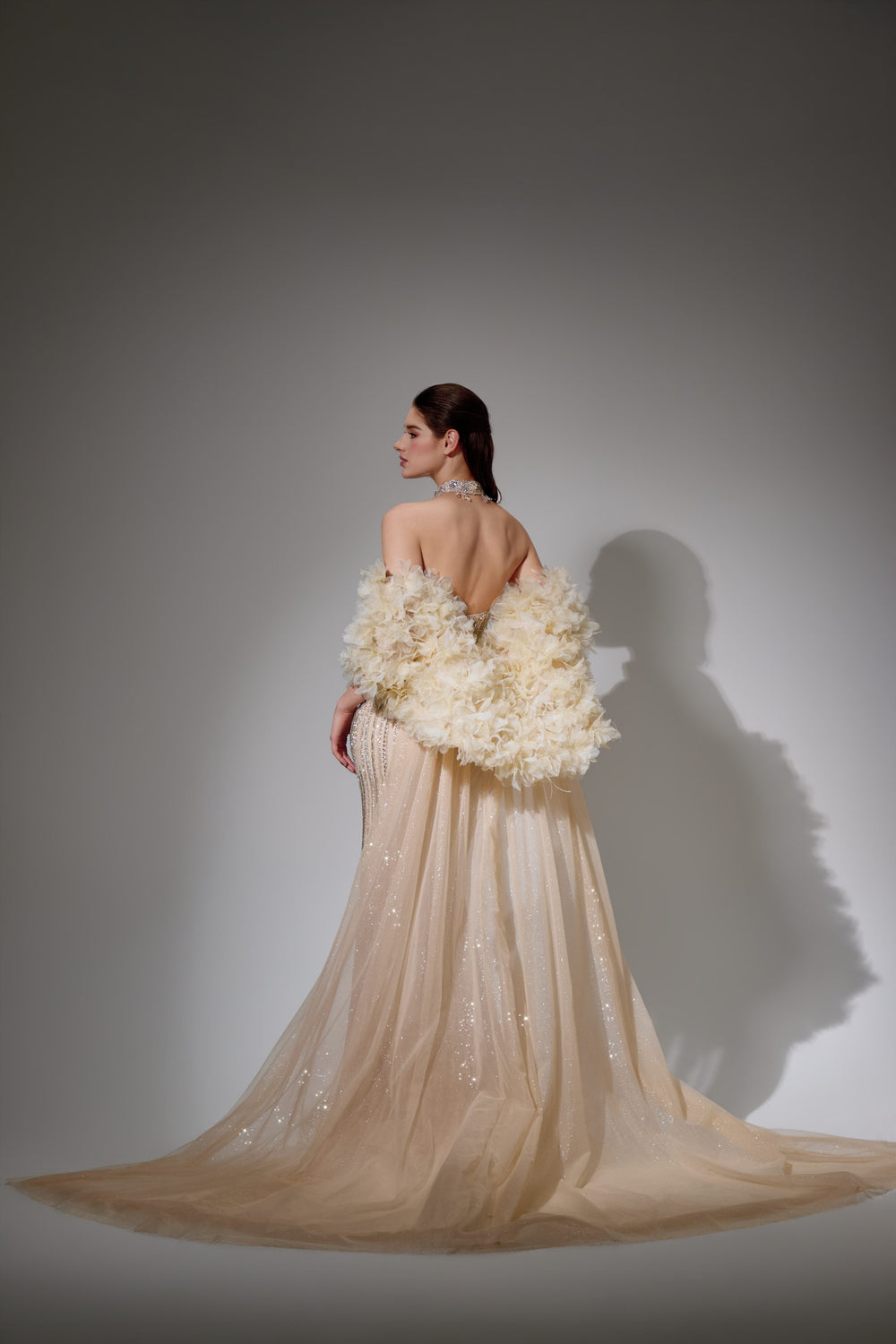 Delilah SH12045 Beaded Halter Plunging Mermaid Gown with Ruffled Arm Puffs and Overskirt - Champagne back view