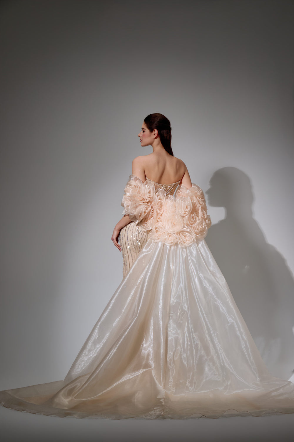 Delilah SH12052 Plunging Beaded Corset Mermaid Gown with Rosette Arm Puffs and Overskirt - Champagne back view